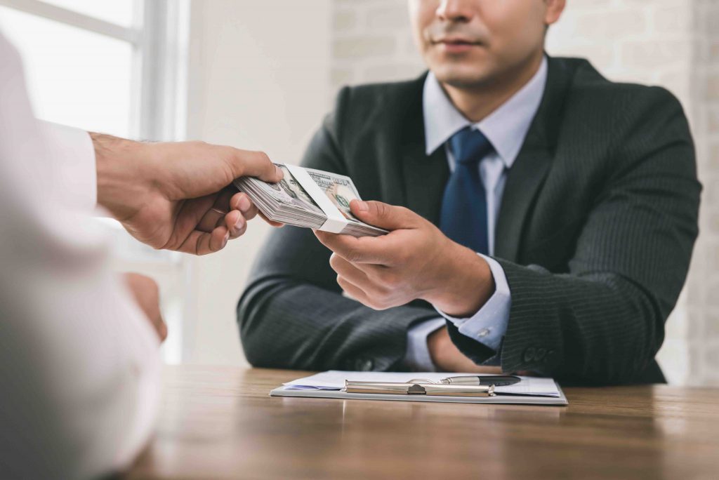 Businessman receiving money after contract signing